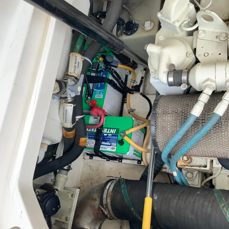 Slide: The Image of Engine compartment of a 2000 Tiara Sport 35 Open boat with batteries and hoses. - 37