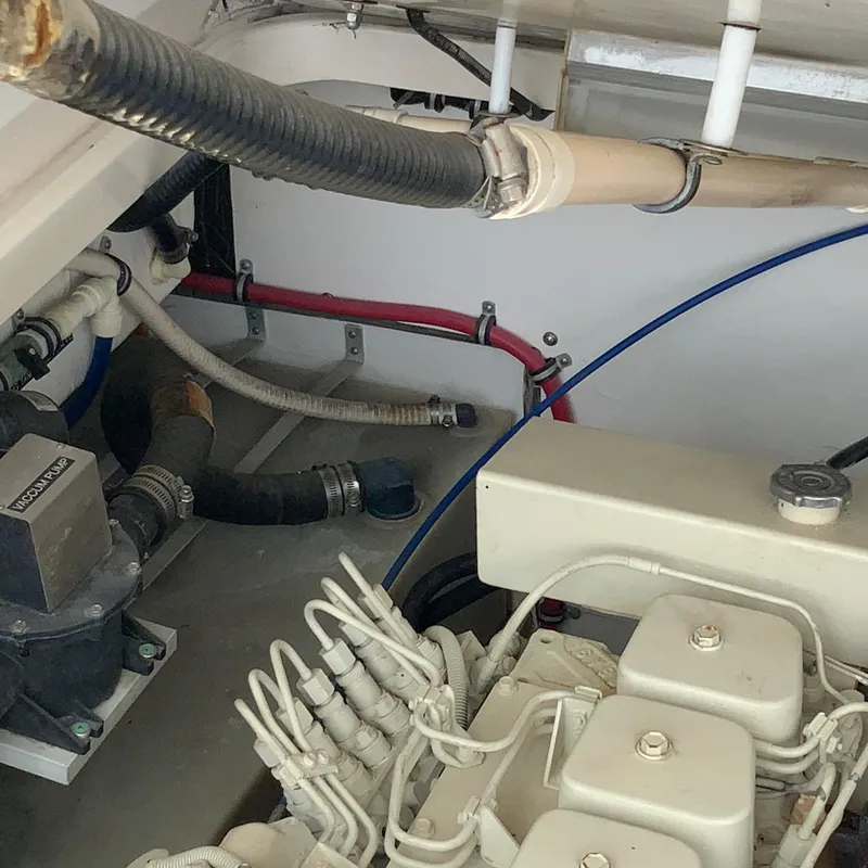 Slide: The Image of Engine compartment of a 2000 Tiara Sport 35 Open boat showing hoses and mechanical components. - 39