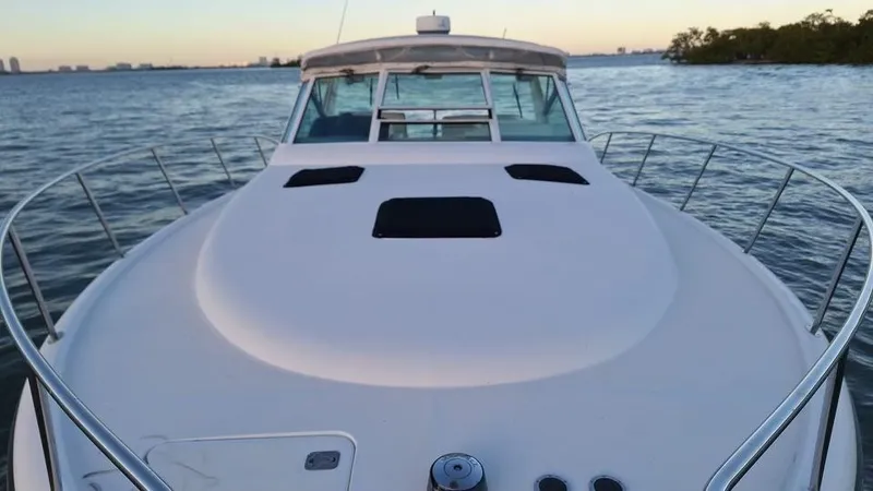 Slide: The Image of 2000 Tiara Sport 35 Open boat on calm waters at sunset. - 6