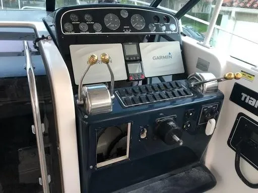 Slide: The Image of Tiara Sport 35 Open 2000 boat helm with Garmin navigation system and dual throttle controls. - 7