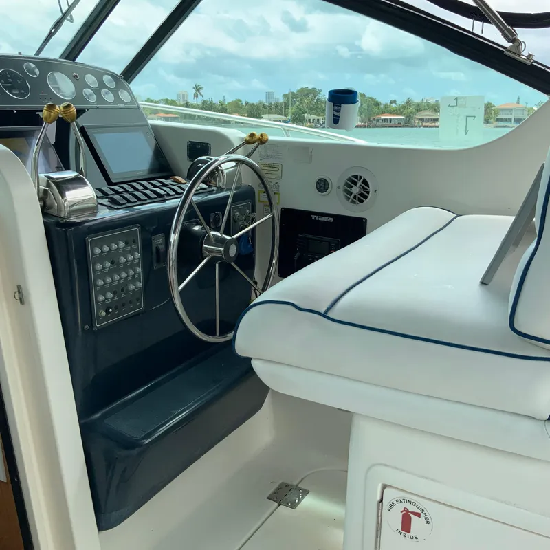 Slide: The Image of Helm of 2000 Tiara Sport 35 Open boat with steering wheel and control panel. - 8