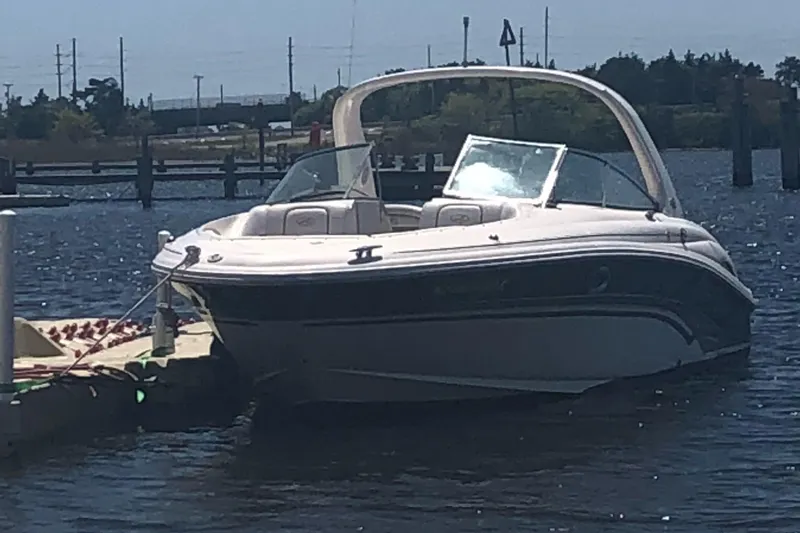 Slide: The Image of 2001 Sea Ray 290 Bowrider docked at a marina on a sunny day. - 14