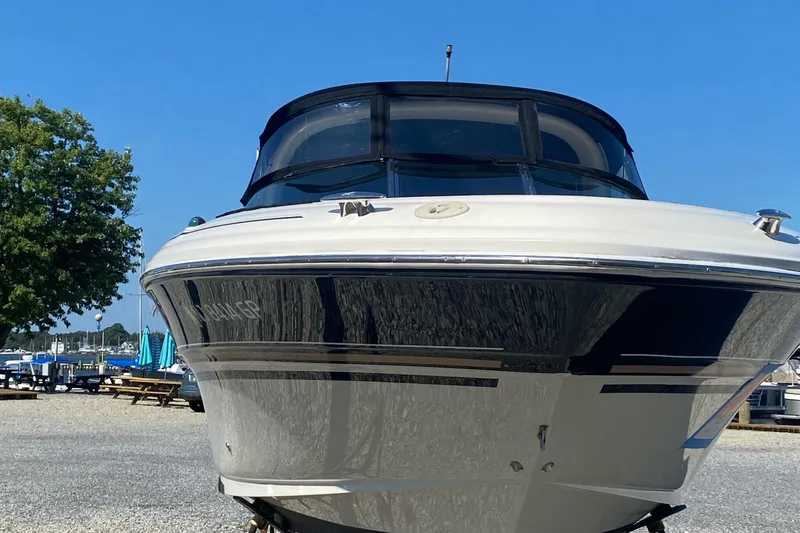 Slide: The Image of 2001 Sea Ray 290 Bowrider boat on dry dock with clear blue sky. - 8
