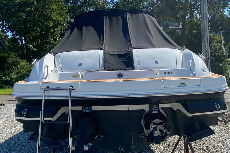 Slide: The Image of 2001 Sea Ray 290 Bowrider boat with black cover, rear view. - 9