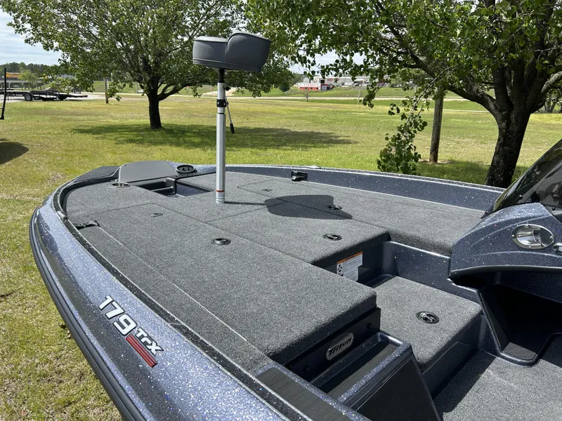 Slide: The Image of 2024 Triton 179 TrX fishing boat deck with storage compartments. - 5