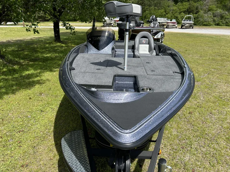 Slide: The Image of 2024 Triton 179 TrX bass boat on grass, front view. - 6