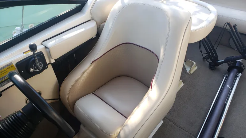 Slide: The Image of 1998 Malibu Sunsetter VLX boat interior with beige captain's seat and steering wheel. - 12