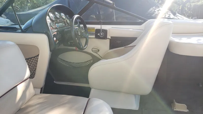 Slide: The Image of 1998 Malibu Sunsetter VLX boat interior with steering wheel and seating. - 17