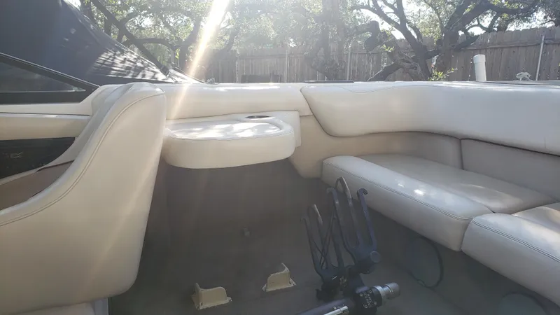 Slide: The Image of 1998 Malibu Sunsetter VLX boat interior with beige seating and sunlight. - 18