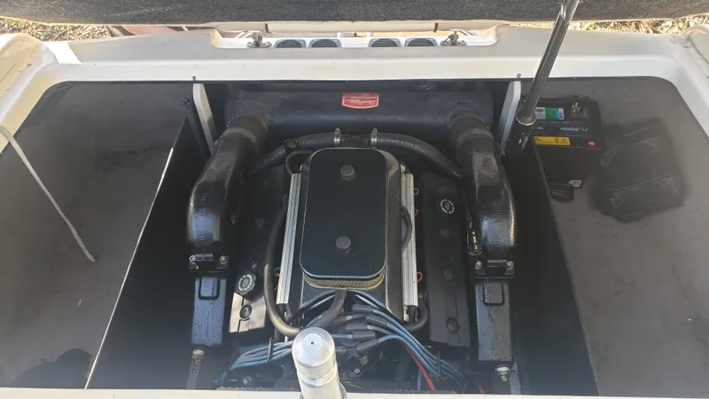 Slide: The Image of 1998 Malibu Sunsetter VLX boat engine compartment with visible engine components. - 20
