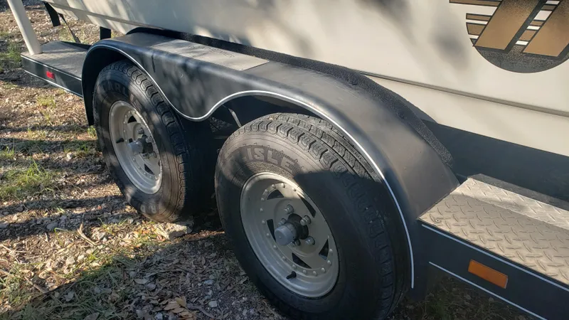 Slide: The Image of Close-up of 1998 Malibu Sunsetter VLX trailer wheels on a sunny day. - 22
