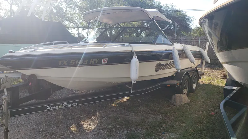 Slide: The Image of 1998 Malibu Sunsetter VLX boat on a trailer in a yard. - 3