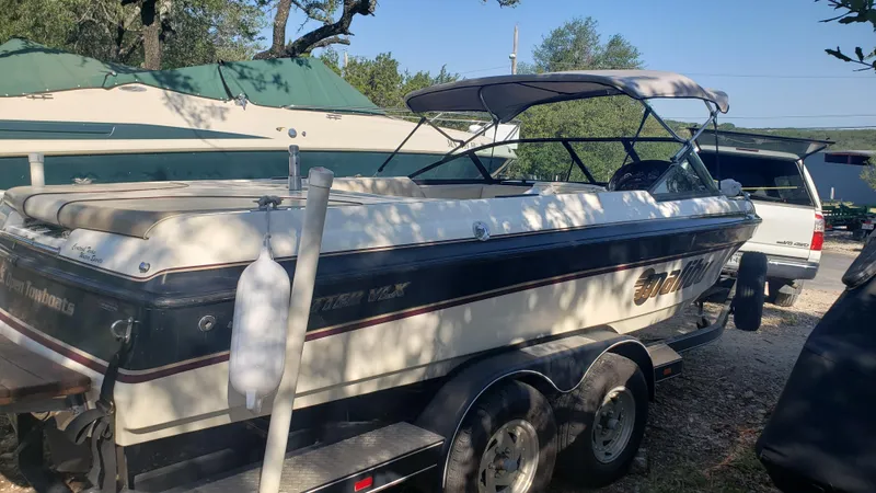 Slide: The Image of 1998 Malibu Sunsetter VLX boat on a trailer in a parking area. - 4