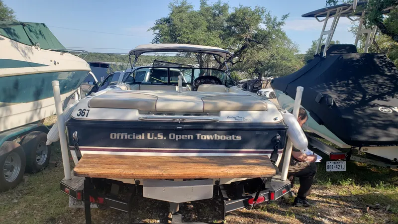 Slide: The Image of 1998 Malibu Sunsetter VLX boat labeled Official U.S. Open Towboats parked among other boats. - 5