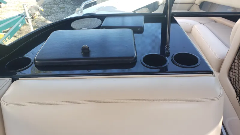 Slide: The Image of 1998 Malibu Sunsetter VLX boat interior with cup holders and storage compartments. - 9