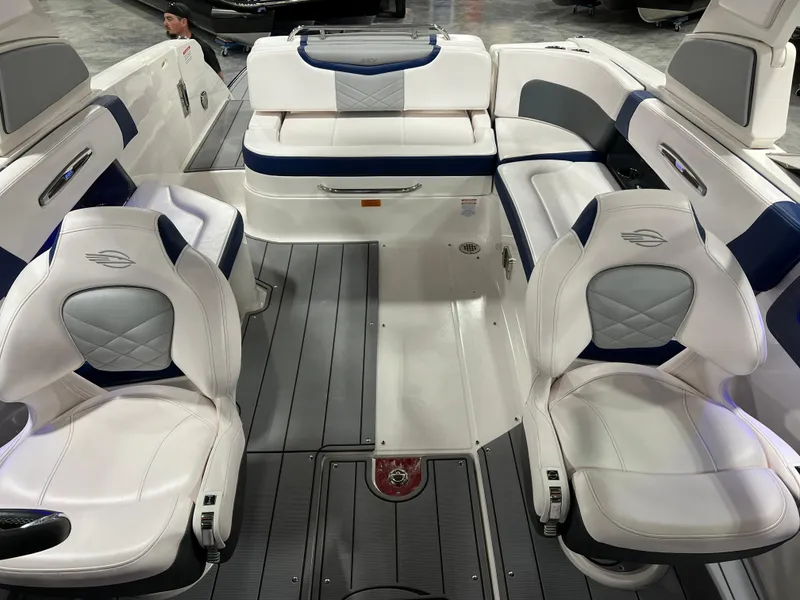 Slide: The Image of 2021 Chaparral 287 SSX boat interior with white and blue seating, featuring modern design. - 11