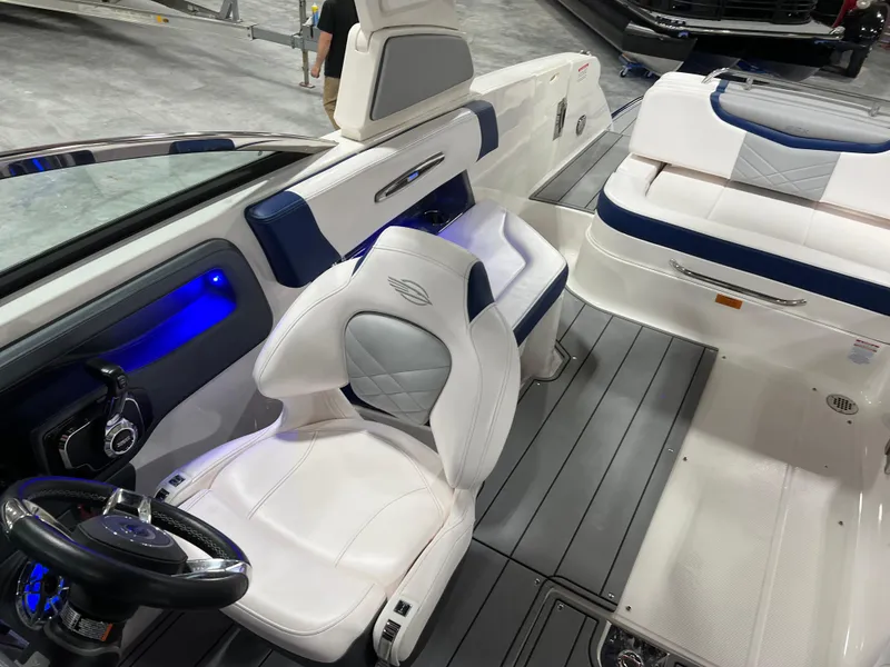 Slide: The Image of 2021 Chaparral 287 SSX boat interior with white and blue seating, modern design. - 12
