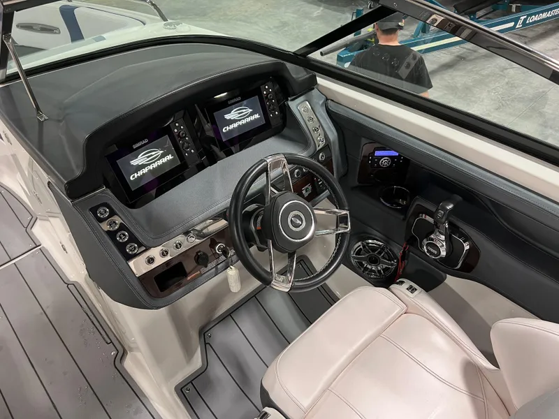 Slide: The Image of 2021 Chaparral 287 SSX boat dashboard with dual displays and steering wheel. - 13