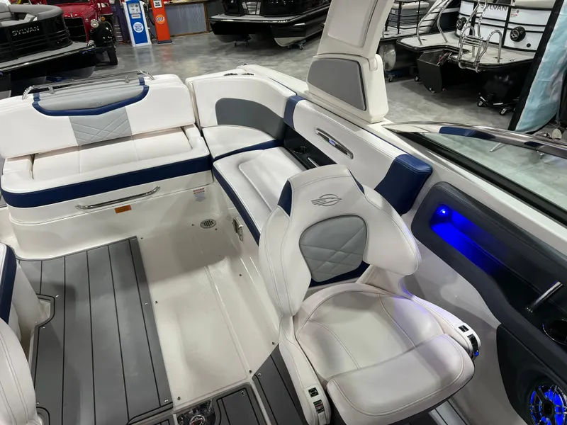 Slide: The Image of 2021 Chaparral 287 SSX boat interior with white and blue seating, modern design. - 14