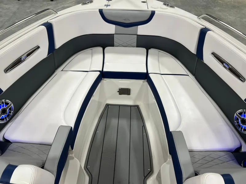 Slide: The Image of 2021 Chaparral 287 SSX boat interior with white and blue seating and modern design. - 9