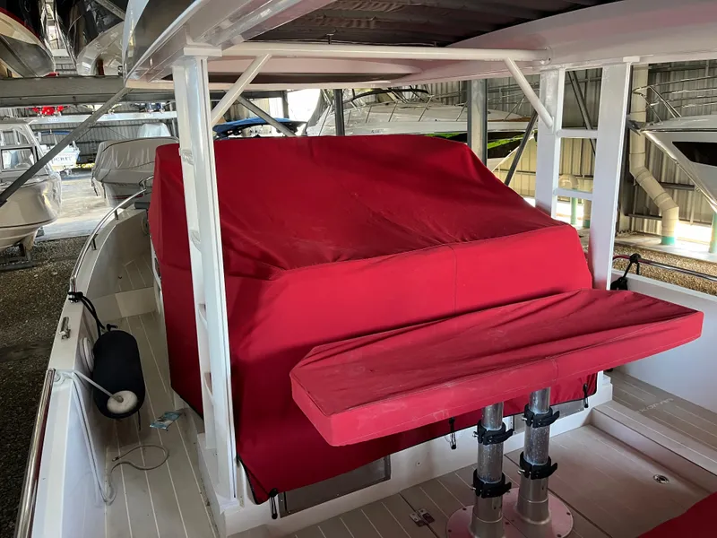Slide: The Image of 2019 Axopar 37 Sun Top boat interior with red cover and seating. - 15