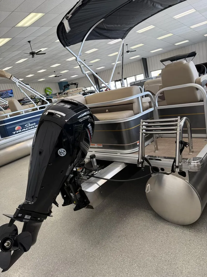 Slide: The Image of 2024 Sun Tracker Party Barge 18 DLX pontoon boat with outboard motor in showroom. - 8