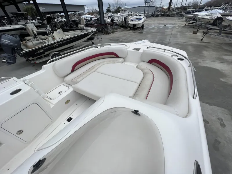 Slide: The Image of 2005 Hurricane 237 boat with white and red seating, docked in a marina. - 7