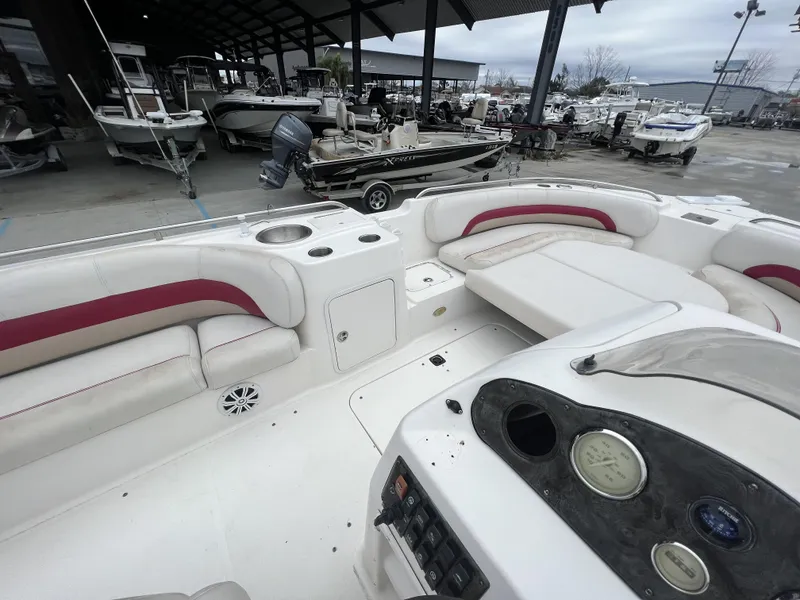 Slide: The Image of 2005 Hurricane 237 boat interior with white and red seating, docked among other boats. - 8