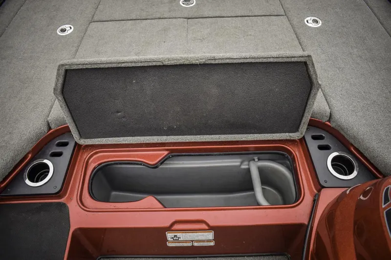 Slide: The Image of 2017 Nitro Z21 boat storage compartment with open lid and cup holders. - 13