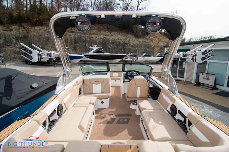 Slide: The Image of 2024 MasterCraft XT24 boat interior with beige seating at Big Thunder Marine. - 13
