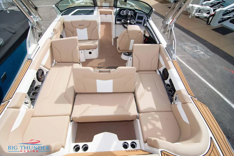 Slide: The Image of 2024 MasterCraft XT24 boat interior with beige seating and modern dashboard. - 15