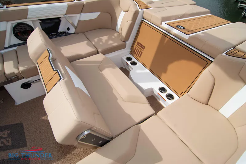 Slide: The Image of 2024 MasterCraft XT24 boat interior with tan upholstery and seating arrangement. - 22