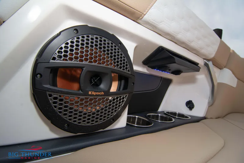 Slide: The Image of Close-up of 2024 MasterCraft XT24 boat interior with Klipsch speaker and cup holders. - 24
