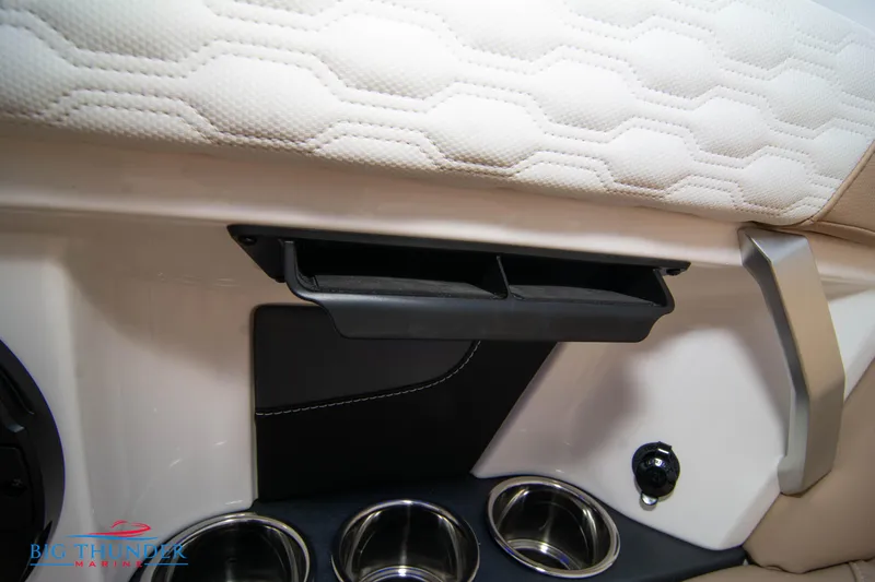 Slide: The Image of 2024 MasterCraft XT24 interior detail with cup holders and storage compartment. - 25