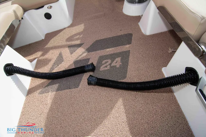 Slide: The Image of 2024 MasterCraft XT24 boat interior with logo and flexible hoses. - 27