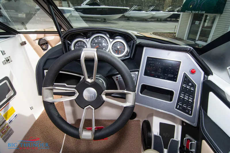 Slide: The Image of 2024 MasterCraft XT24 boat dashboard with steering wheel and control panel. - 30
