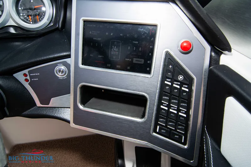 Slide: The Image of 2024 MasterCraft XT24 boat dashboard with touchscreen and control panel. - 32