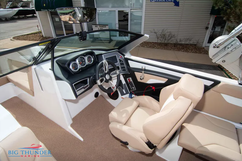 Slide: The Image of 2024 MasterCraft XT24 boat interior with beige seats and modern dashboard. - 35