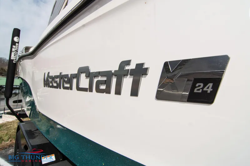 Slide: The Image of 2024 MasterCraft XT24 boat side view with logo and model name. - 4