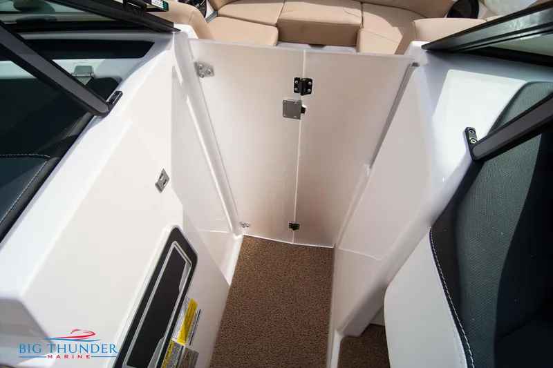 Slide: The Image of 2024 MasterCraft XT24 boat interior with beige seating and storage compartment. - 40