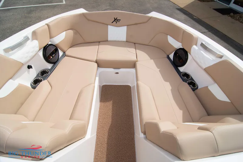 Slide: The Image of 2024 MasterCraft XT24 boat with beige seating and integrated speakers. - 41