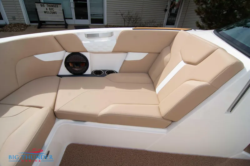 Slide: The Image of 2024 MasterCraft XT24 boat interior with beige seating and built-in speaker. - 42