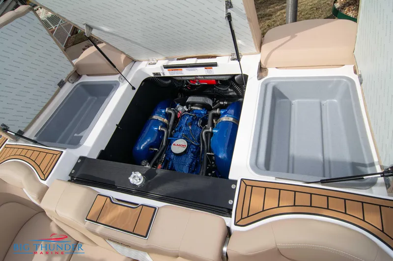 Slide: The Image of 2024 MasterCraft XT24 boat engine compartment with open hatches. - 49