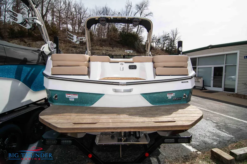 Slide: The Image of 2024 MasterCraft XT24 boat with teak swim platform, rear view. - 6