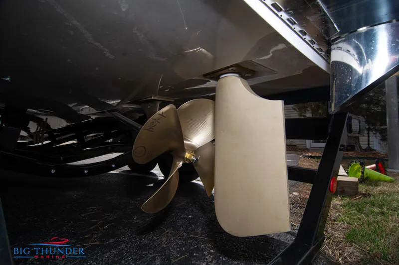 Slide: The Image of 2024 MasterCraft XT24 boat propeller and rudder on trailer. - 8