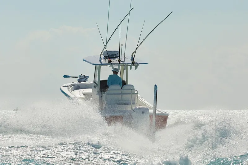 Slide: The Image of 2024 Regulator 26XO boat docked at a marina with scenic waterfront view. - 3