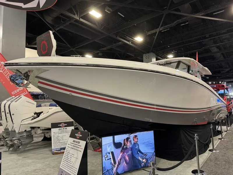 Slide: The Image of 2025 Fountain 43 SCX boat displayed at an indoor boat show. - 18