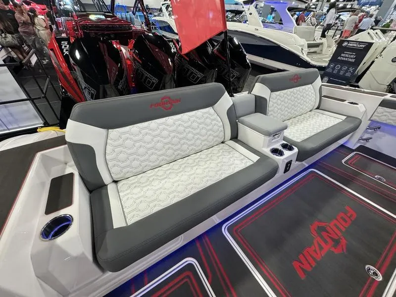 Slide: The Image of 2025 Fountain 43 SCX boat interior with gray and white seating at a boat show. - 19