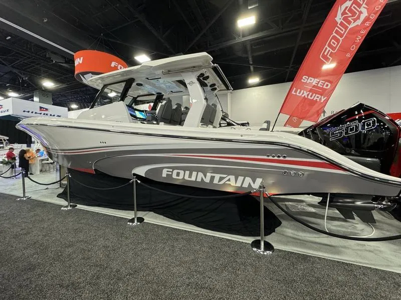 Slide: The Image of 2025 Fountain 43 SCX luxury speed boat on display at an indoor boat show. - 2