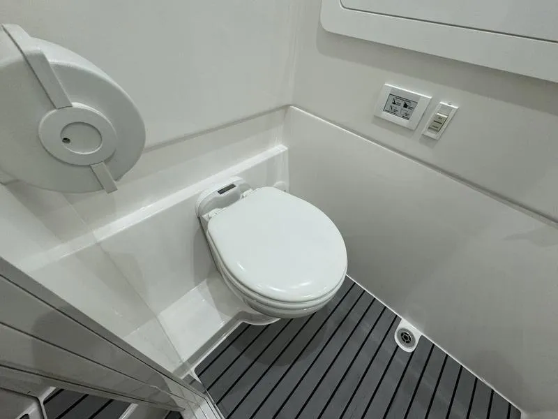Slide: The Image of 2025 Fountain 43 SCX boat bathroom with modern toilet and sleek design. - 20